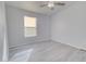 Well-lit bedroom with gray walls, vinyl flooring, and a ceiling fan at 10991 W Hilltop Dr, Casa Grande, AZ 85193