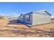 Side view of manufactured home with landscaping and desert views at 10991 W Hilltop Dr, Casa Grande, AZ 85193