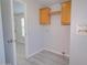 Laundry room with wooden cabinets and vinyl flooring at 10991 W Hilltop Dr, Casa Grande, AZ 85193