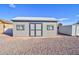 Gray storage shed with double doors and windows at 10991 W Hilltop Dr, Casa Grande, AZ 85193