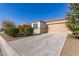 Front view of a house with a garage and desert landscaping at 1154 W Lowell Dr, San Tan Valley, AZ 85140