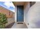 Inviting front door entrance with blue door and small patio at 1154 W Lowell Dr, San Tan Valley, AZ 85140