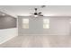 Spacious living room featuring tile floors and ceiling fan at 1154 W Lowell Dr, San Tan Valley, AZ 85140