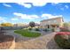 Landscaped backyard with a kidney shaped pool and grassy area at 12503 S 175Th Ave, Goodyear, AZ 85338