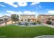 Large backyard with a kidney shaped pool and lush green grass at 12503 S 175Th Ave, Goodyear, AZ 85338