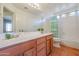 Bathroom boasts double sinks, a shower/tub combo, and wood cabinets at 12503 S 175Th Ave, Goodyear, AZ 85338