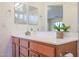 Double vanity bathroom with wood cabinets and large mirrors at 12503 S 175Th Ave, Goodyear, AZ 85338