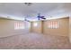 Large bedroom with two ceiling fans and carpeted floor at 12503 S 175Th Ave, Goodyear, AZ 85338