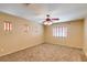 Primary bedroom with ceiling fan and ensuite bathroom at 12503 S 175Th Ave, Goodyear, AZ 85338