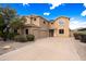 Two-story home with a three-car garage, desert landscaping, and a paved driveway at 12503 S 175Th Ave, Goodyear, AZ 85338