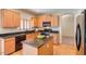 Modern kitchen with island and dark granite countertops at 12503 S 175Th Ave, Goodyear, AZ 85338