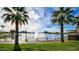 Scenic lakefront view with palm trees and a fountain at 12503 S 175Th Ave, Goodyear, AZ 85338