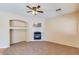 Living room with a fireplace and ceiling fan at 12503 S 175Th Ave, Goodyear, AZ 85338