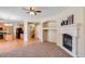 Spacious living room featuring a fireplace and built-in shelving at 12503 S 175Th Ave, Goodyear, AZ 85338