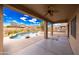 Covered patio overlooking a backyard oasis with a pool and desert landscaping at 12503 S 175Th Ave, Goodyear, AZ 85338