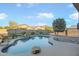 Stunning pool with waterfall feature and rock landscaping at 12503 S 175Th Ave, Goodyear, AZ 85338