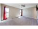 Spacious bedroom with carpet flooring and red curtains at 12619 N Sun Valley Dr, Sun City, AZ 85351