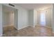 Light-filled hallway with tile flooring and access to other rooms at 12619 N Sun Valley Dr, Sun City, AZ 85351