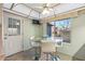 Kitchen nook with glass-top table and four white chairs at 12630 W Crystal Lake Dr, Sun City West, AZ 85375