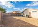 Spacious backyard with patio, grassy area, and block wall at 12907 W Sharon Dr, El Mirage, AZ 85335