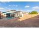 Large backyard with patio, grassy area, and block wall at 12907 W Sharon Dr, El Mirage, AZ 85335