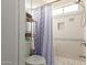 Clean bathroom with a shower/tub, toilet, and shelving unit at 12907 W Sharon Dr, El Mirage, AZ 85335