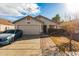 Single-story home with attached garage and landscaped yard at 12907 W Sharon Dr, El Mirage, AZ 85335