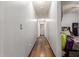 Clean hallway with light walls and wood-look flooring leading to other rooms at 12907 W Sharon Dr, El Mirage, AZ 85335