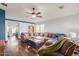 Spacious living room with L-shaped sectional sofa and wood floors at 12907 W Sharon Dr, El Mirage, AZ 85335