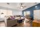 Living room with sectional sofa, wood floors, and blue accent wall at 12907 W Sharon Dr, El Mirage, AZ 85335