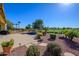 Landscaped backyard with pool, patio, and golf course views at 13105 W Micheltorena Dr, Sun City West, AZ 85375