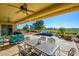 Covered patio with seating area, pool, and golf course view at 13105 W Micheltorena Dr, Sun City West, AZ 85375