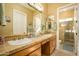 Bathroom with double sinks and a shower at 13105 W Micheltorena Dr, Sun City West, AZ 85375