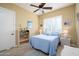 Bright bedroom with a double bed, built-in shelving, and tiled floor at 13105 W Micheltorena Dr, Sun City West, AZ 85375