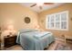 Comfortable bedroom with a queen-size bed and window seating at 13105 W Micheltorena Dr, Sun City West, AZ 85375