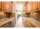 Butler's pantry with granite countertop and wine cooler at 13105 W Micheltorena Dr, Sun City West, AZ 85375