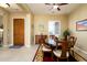 Formal dining room with wood table and chairs, near entryway at 13105 W Micheltorena Dr, Sun City West, AZ 85375