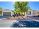 Single-story home with attractive landscaping and a two-car garage at 13105 W Micheltorena Dr, Sun City West, AZ 85375