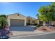 Tan house exterior with a three-car garage and landscaping at 13105 W Micheltorena Dr, Sun City West, AZ 85375