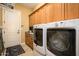 Laundry room with washer, dryer, and cabinets at 13105 W Micheltorena Dr, Sun City West, AZ 85375