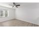 Bright bedroom with ceiling fan and wood-look floors at 14203 N 19Th Ave # 1051, Phoenix, AZ 85023