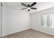 Bright bedroom with ceiling fan and wood-look floors at 14203 N 19Th Ave # 1051, Phoenix, AZ 85023