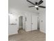 Bedroom with ceiling fan, bathroom access, and wood-look floors at 14203 N 19Th Ave # 1051, Phoenix, AZ 85023