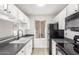 Modern kitchen featuring white cabinets and granite countertops at 14203 N 19Th Ave # 1051, Phoenix, AZ 85023