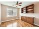 Bedroom with wood floors, ceiling fan and built-in shelving at 1486 E Augusta Ave, Chandler, AZ 85249