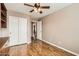 Bedroom with wood floors, ceiling fan and access to hallway at 1486 E Augusta Ave, Chandler, AZ 85249