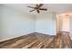 Bedroom with wood floors, ceiling fan and built-in shelving at 1486 E Augusta Ave, Chandler, AZ 85249