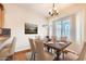 Bright dining room with wood table and six chairs, plus large window at 1486 E Augusta Ave, Chandler, AZ 85249