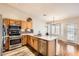 Open kitchen with stainless steel appliances and wood cabinets at 1486 E Augusta Ave, Chandler, AZ 85249