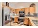 Kitchen with stainless steel appliances and wood cabinets at 1486 E Augusta Ave, Chandler, AZ 85249